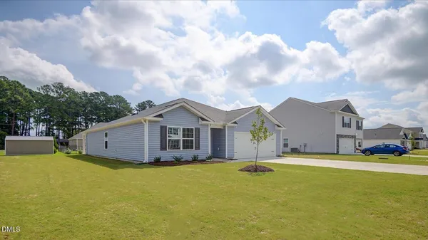 a view of a large house with a big yard