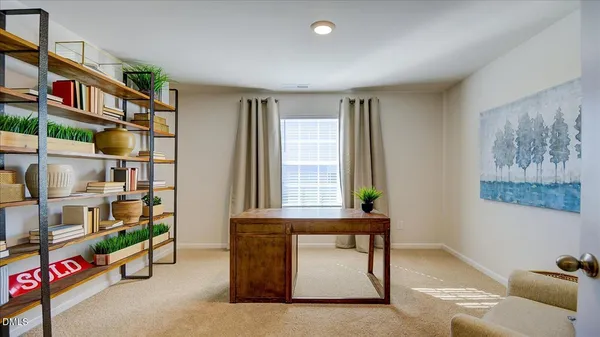 a living room with fish tank and a bookshelf