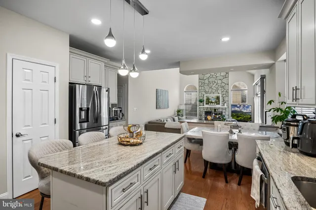 a kitchen with a table chairs and white cabinets