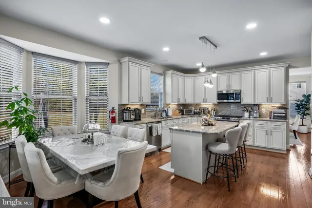 a kitchen with counter space dining table and chairs