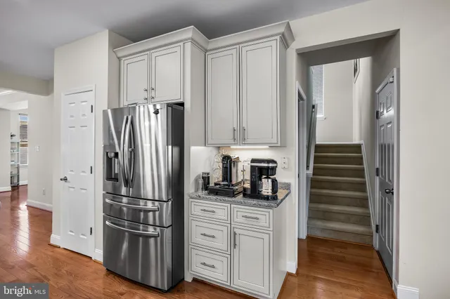 a kitchen with stainless steel appliances and refrigerator