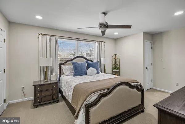 a living room with furniture a air conditioner vent and a window