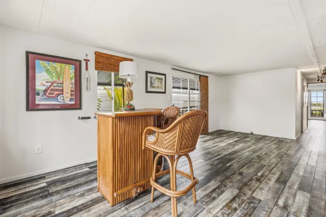 a view of a livingroom with wooden floor and furniture