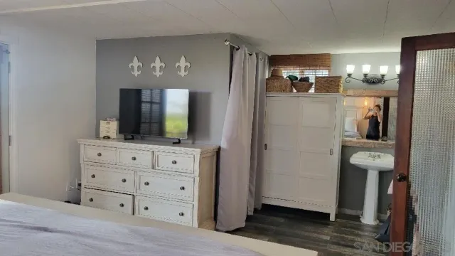 a view of a hallway with livingroom and furniture