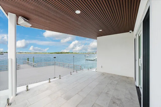 a kitchen with white cabinets and refrigerator
