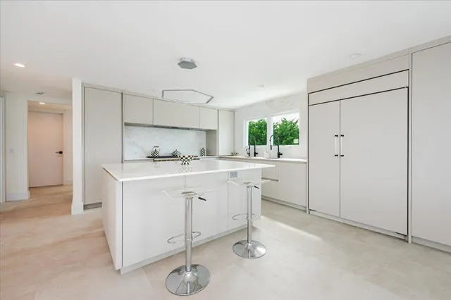a kitchen that has a sink and a stove in it