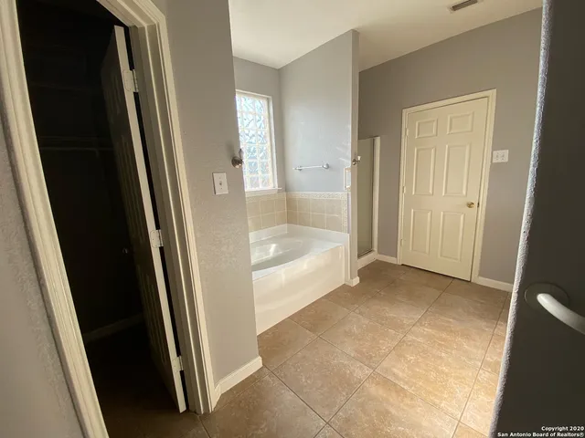 a bathroom with a glass shower door