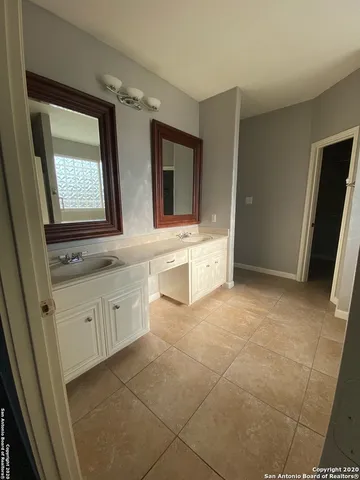 a bathroom with a sink a mirror and a bathtub