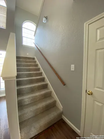 an empty room with a ceiling fan and glass door