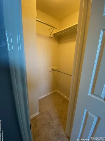 a bathroom with a granite countertop sink a mirror and a bathtub