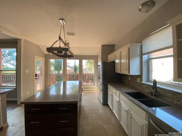 a kitchen with granite countertop a sink and a stove