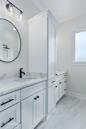 a bathroom with a granite countertop sink and a mirror