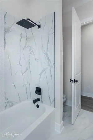 a bathroom with a bathtub and a shower
