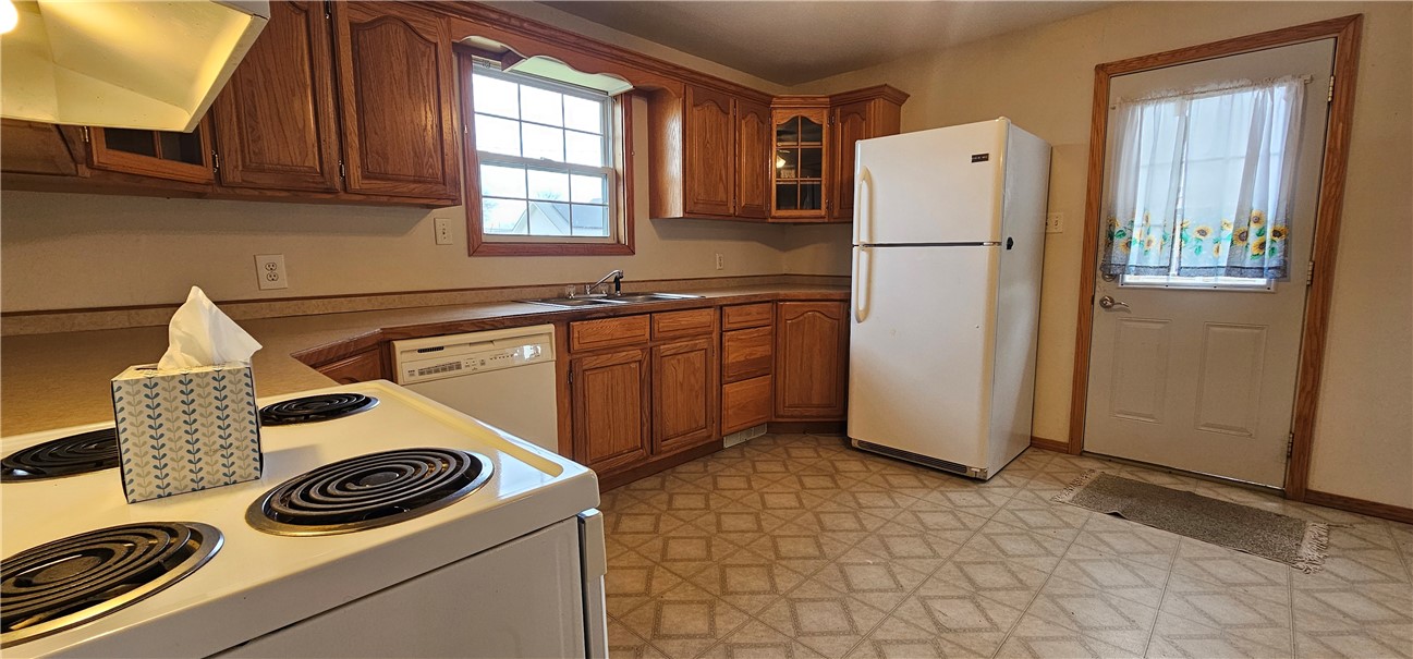 206 East Fifth Street St. Peter, IL 62880 - Photo 3 of 23 a kitchen with a refrigerator and a stove top oven