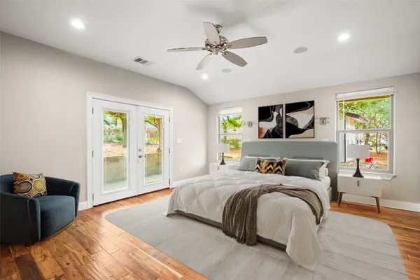 a bedroom with a bed and wooden floor