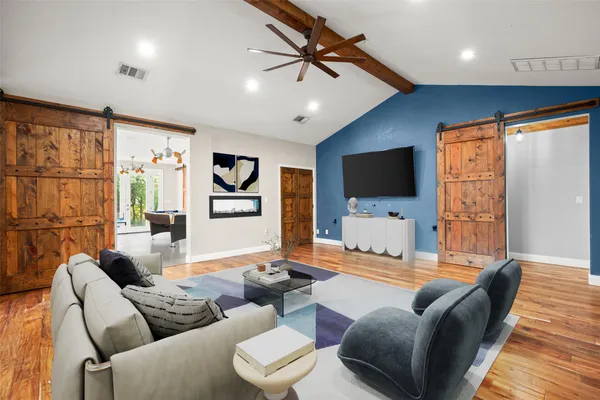 a living room with furniture and a flat screen tv