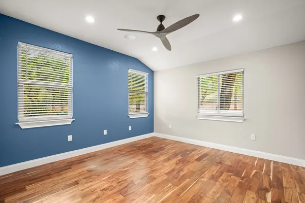 a view of a livingroom with a ceiling fan and window