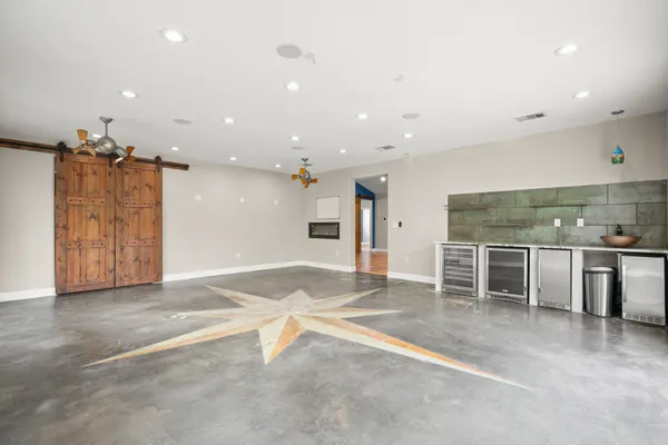 an empty room with wooden floor and window