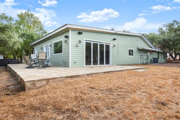 a backyard of a house with table and chairs