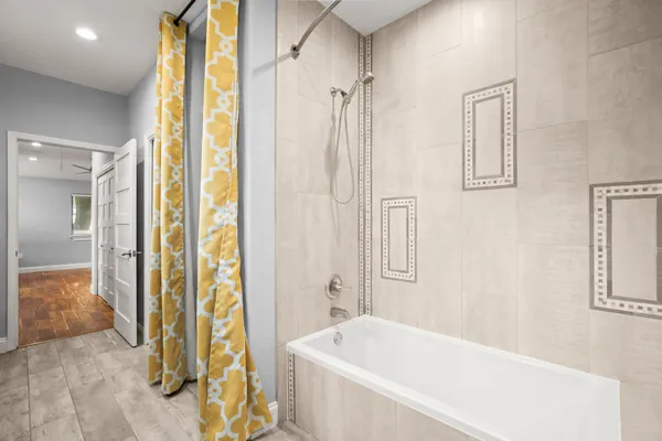 a bathroom with a tub and shower
