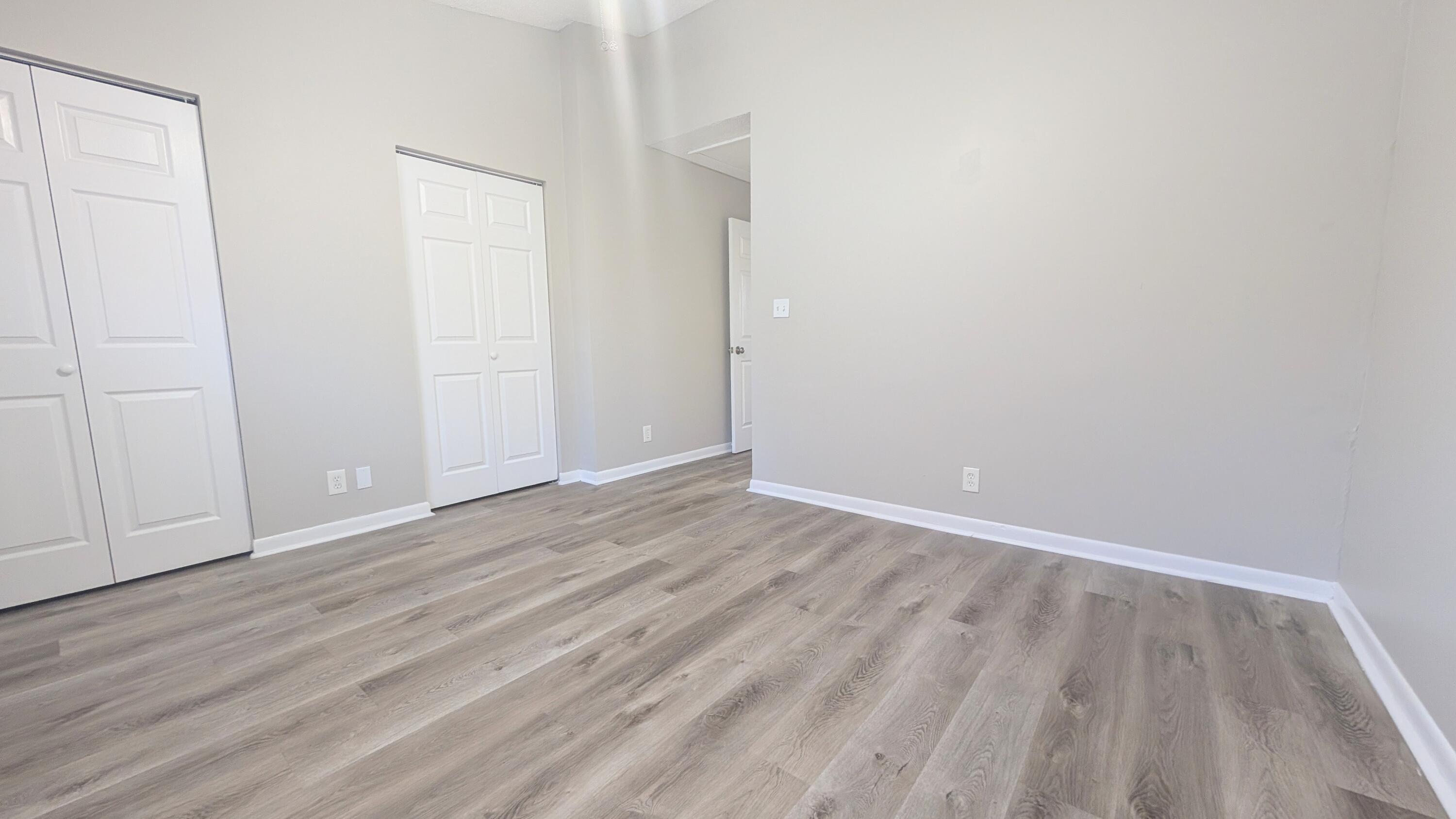 8341 Fairway Road Sunrise, FL 33351 - Photo 13 of 15 a view of an empty room with wooden floor