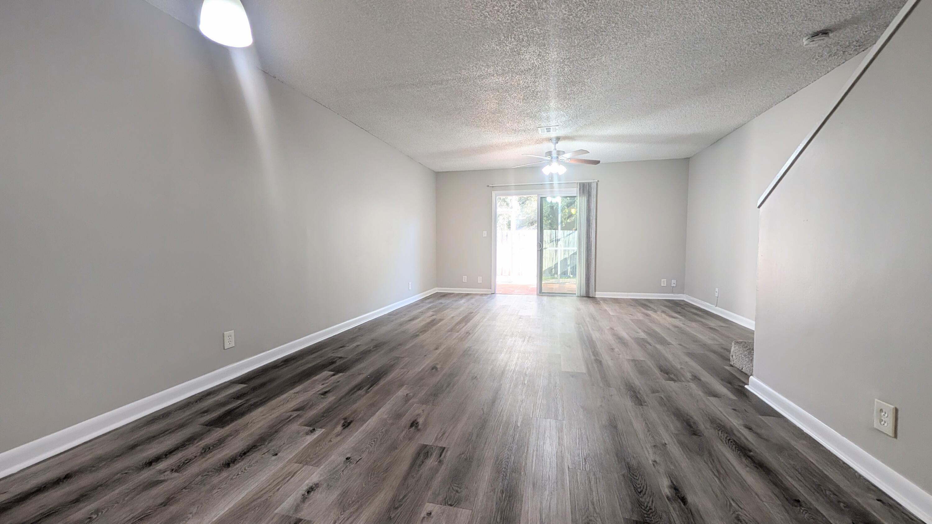 8341 Fairway Road Sunrise, FL 33351 - Photo 4 of 15 a view of an empty room with wooden floor and a window