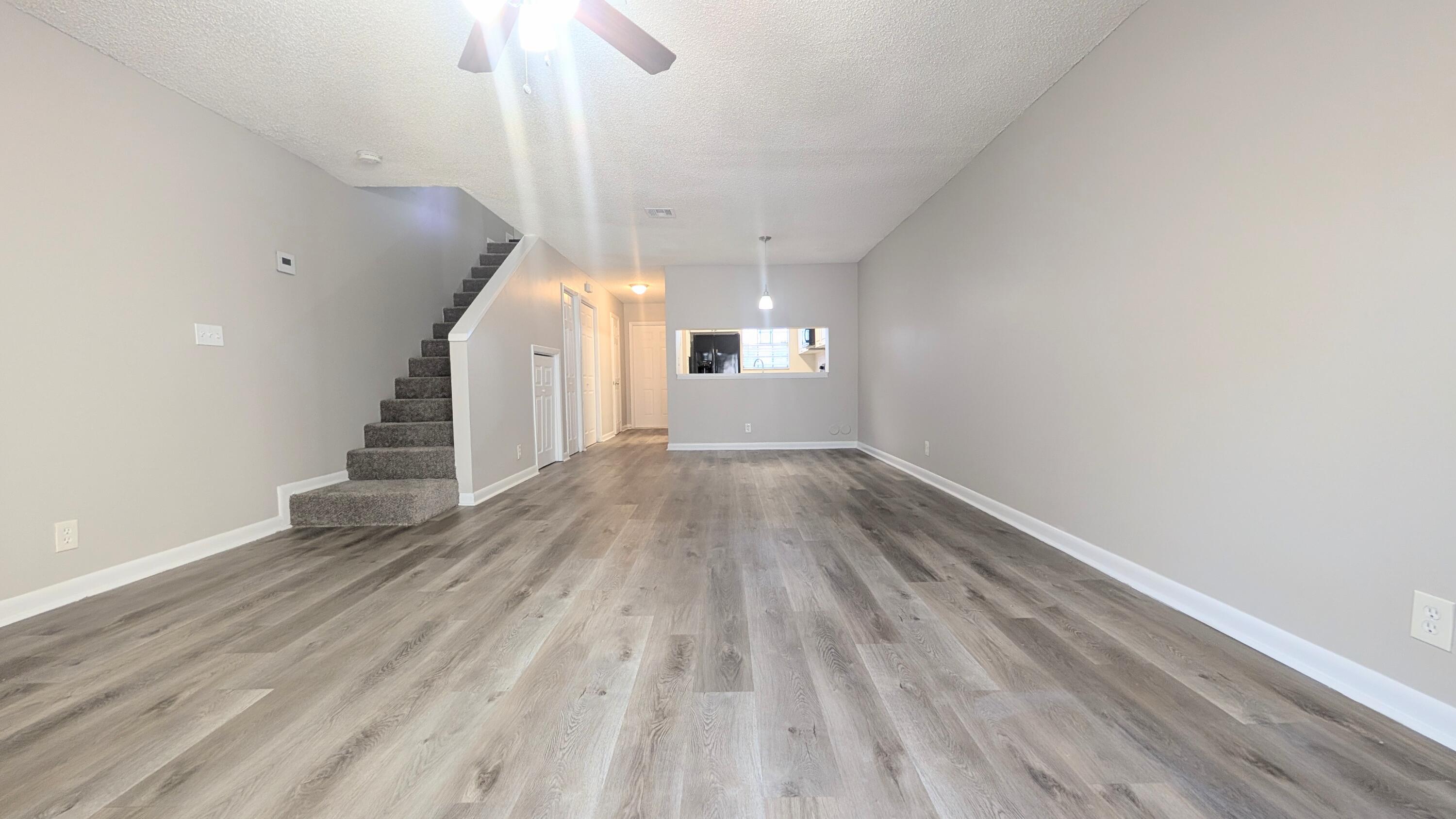 8341 Fairway Road Sunrise, FL 33351 - Photo 5 of 15 a view of a room with wooden floor ceiling fan and window