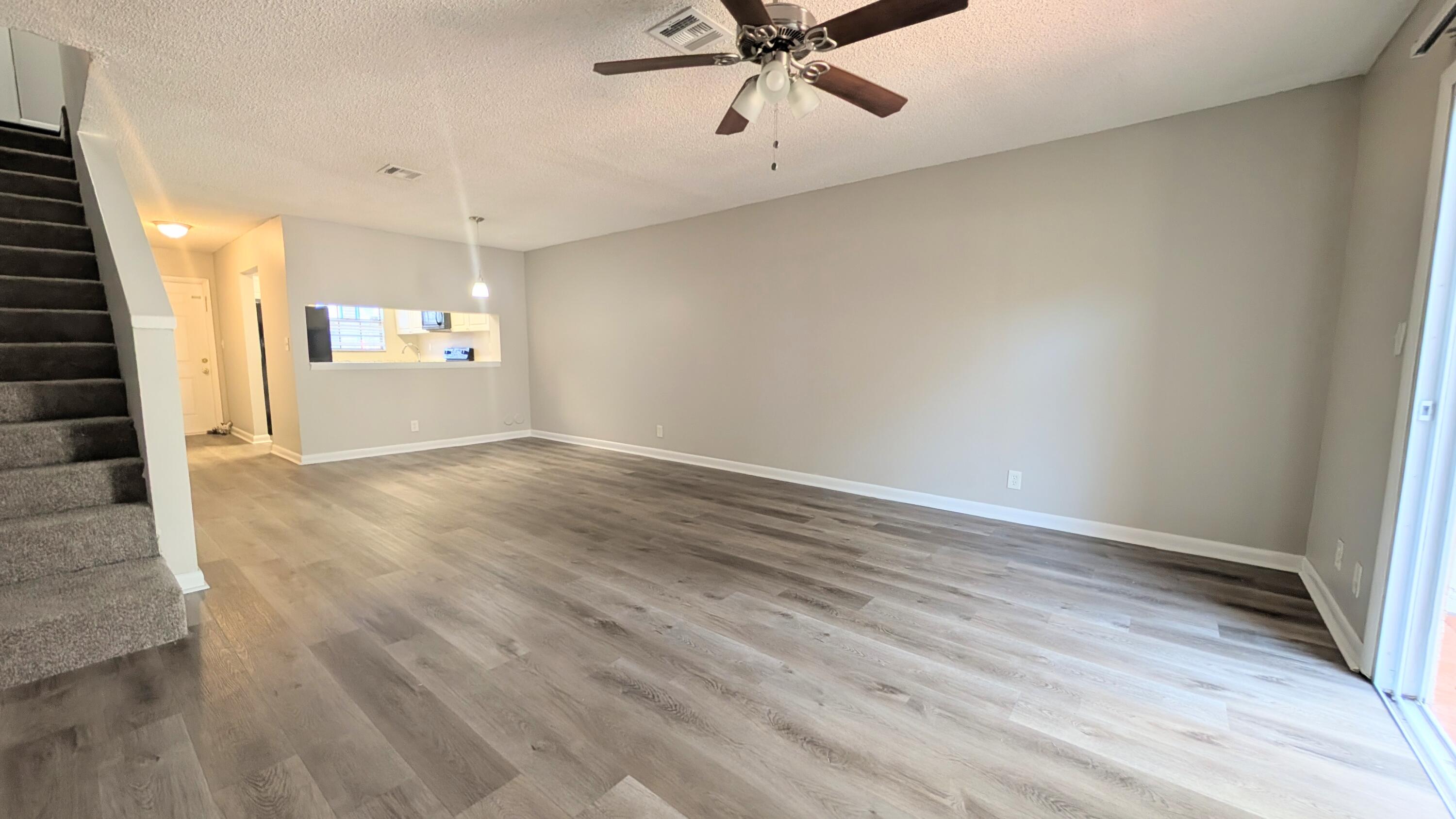 8341 Fairway Road Sunrise, FL 33351 - Photo 7 of 15 an empty room with wooden floor and windows