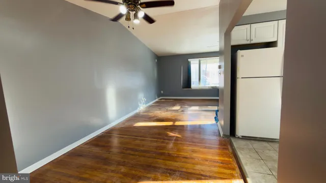a kitchen with a sink refrigerator and cabinets