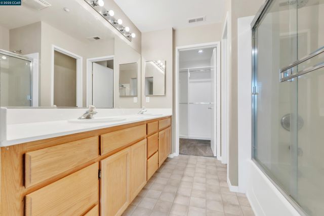 a bathroom with a double vanity sink and a mirror