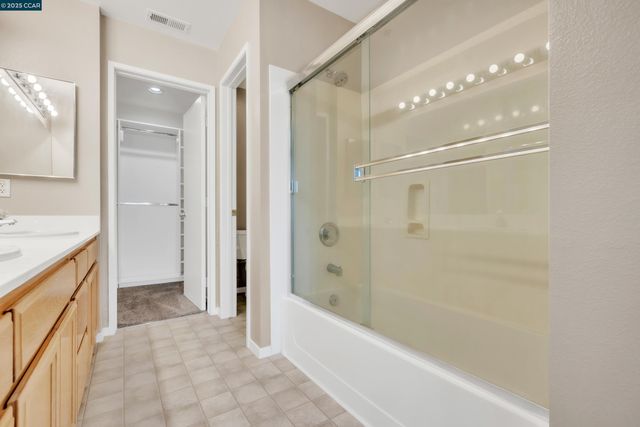 a bathroom with a bathtub shower and a sink