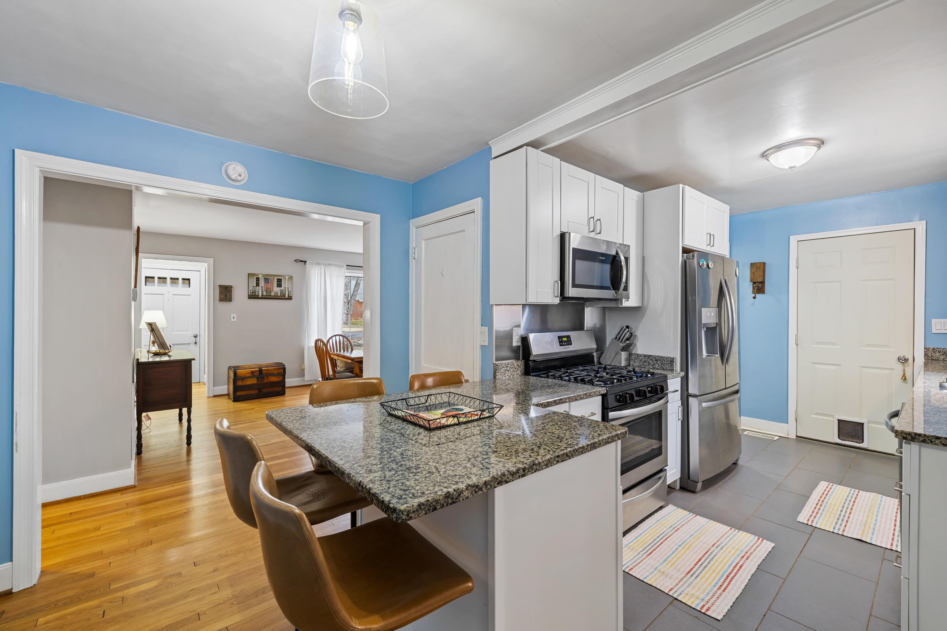 212 Alphin Avenue Waynesboro, VA 22980 - Photo 13 of 63 a kitchen with sink refrigerator and dining table