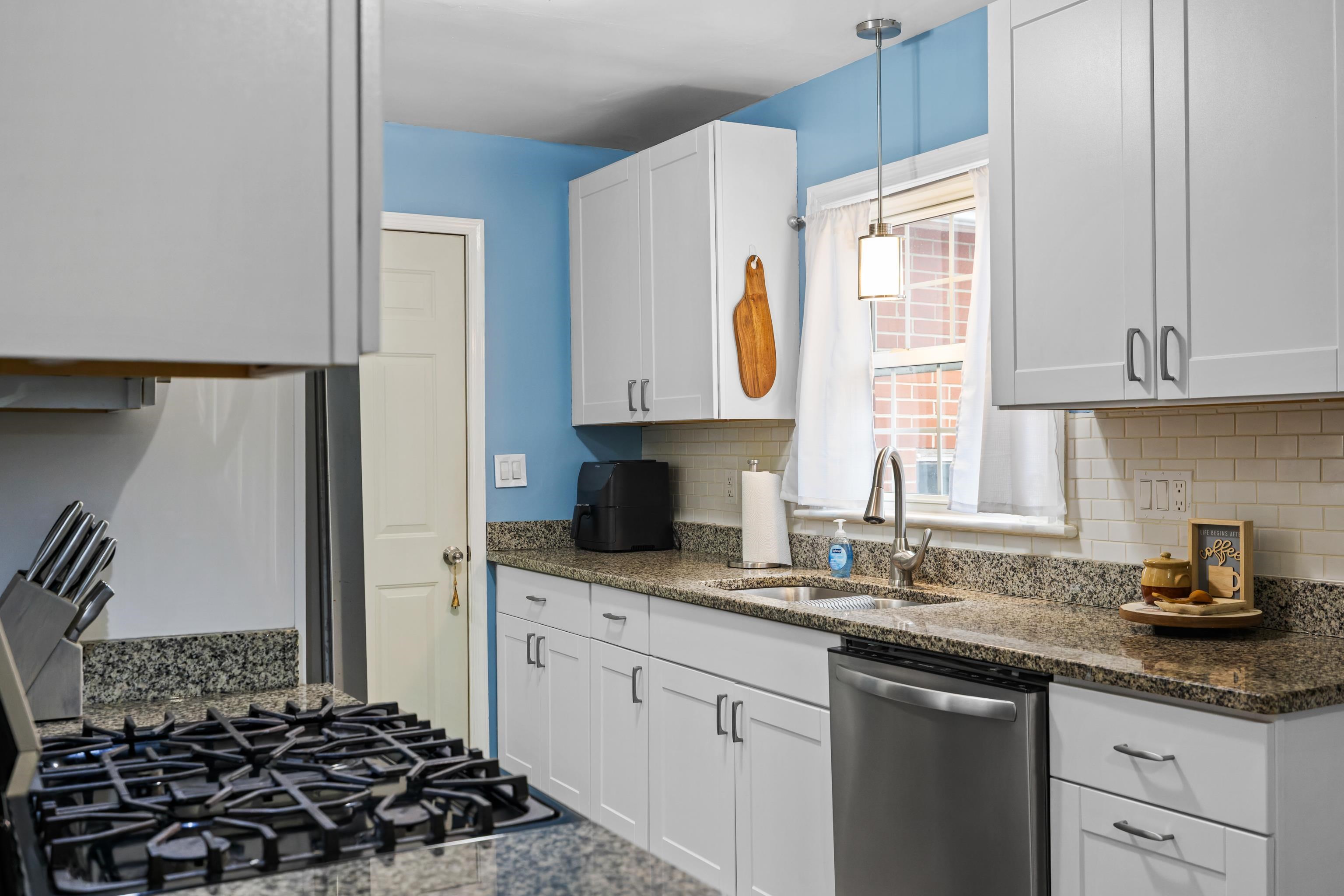 212 Alphin Avenue Waynesboro, VA 22980 - Photo 14 of 63 a kitchen with granite countertop a sink and a stove top oven