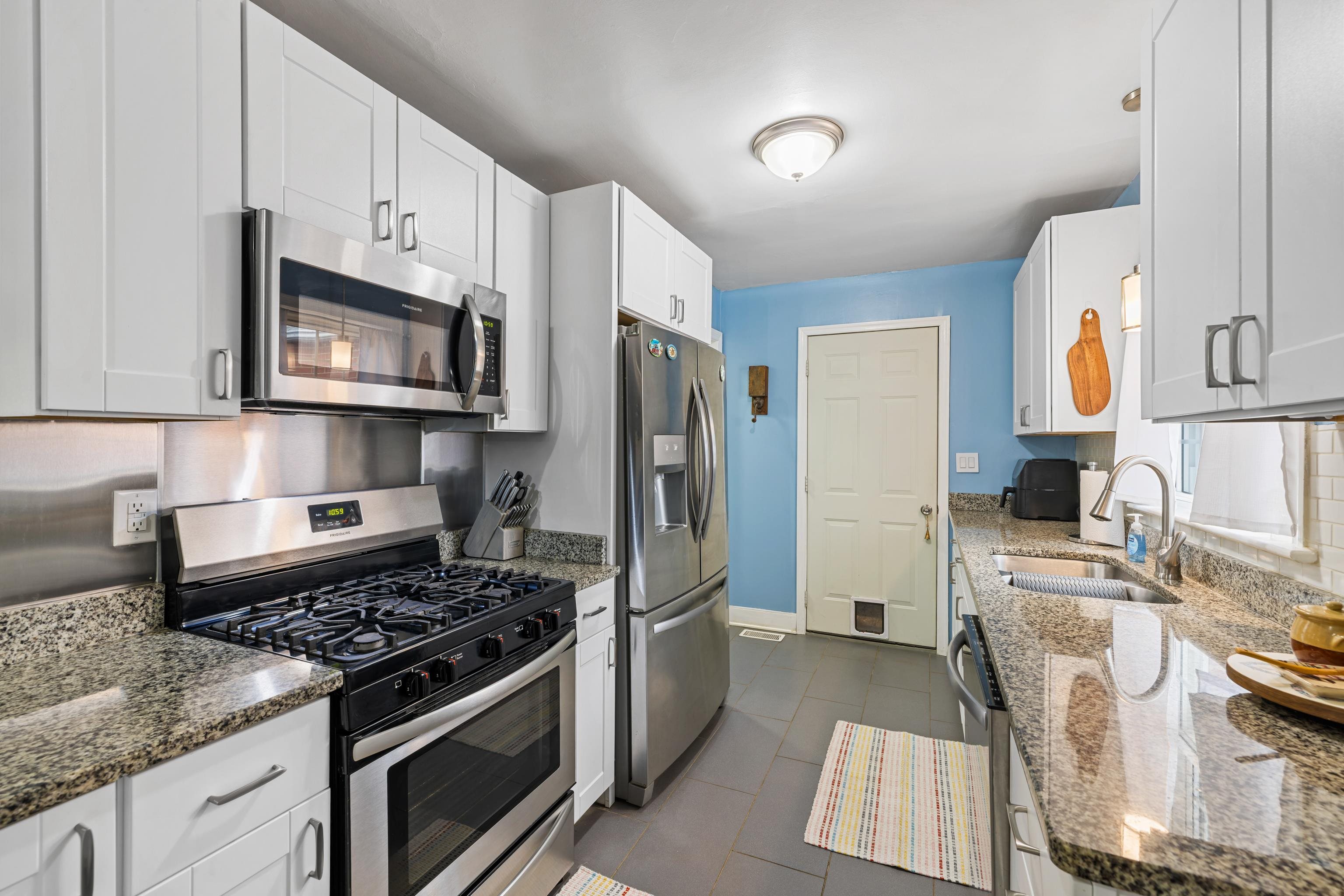 212 Alphin Avenue Waynesboro, VA 22980 - Photo 15 of 63 a kitchen with stainless steel appliances granite countertop a stove a refrigerator and a microwave