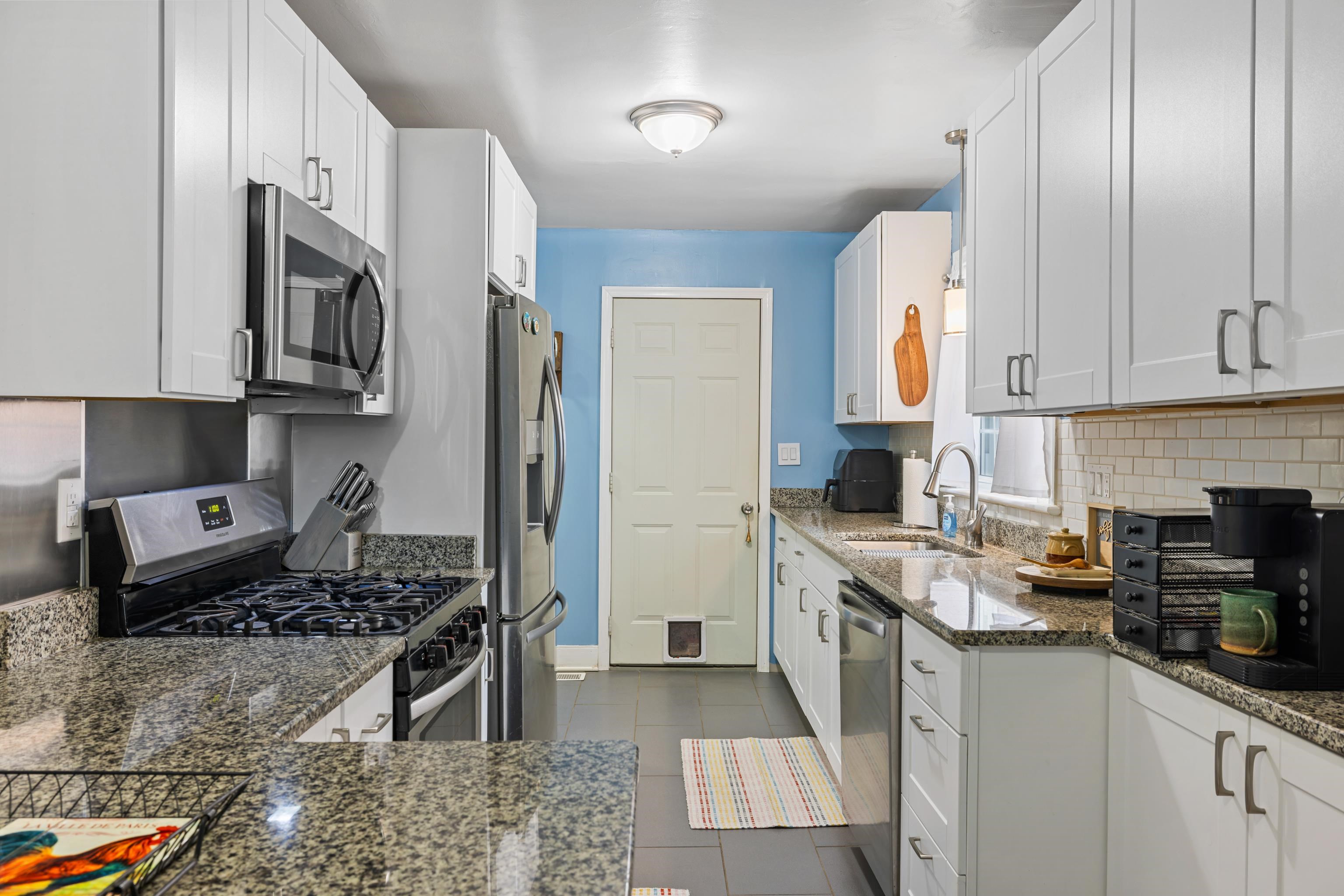 212 Alphin Avenue Waynesboro, VA 22980 - Photo 16 of 63 a kitchen with stainless steel appliances granite countertop a stove sink microwave and cabinets