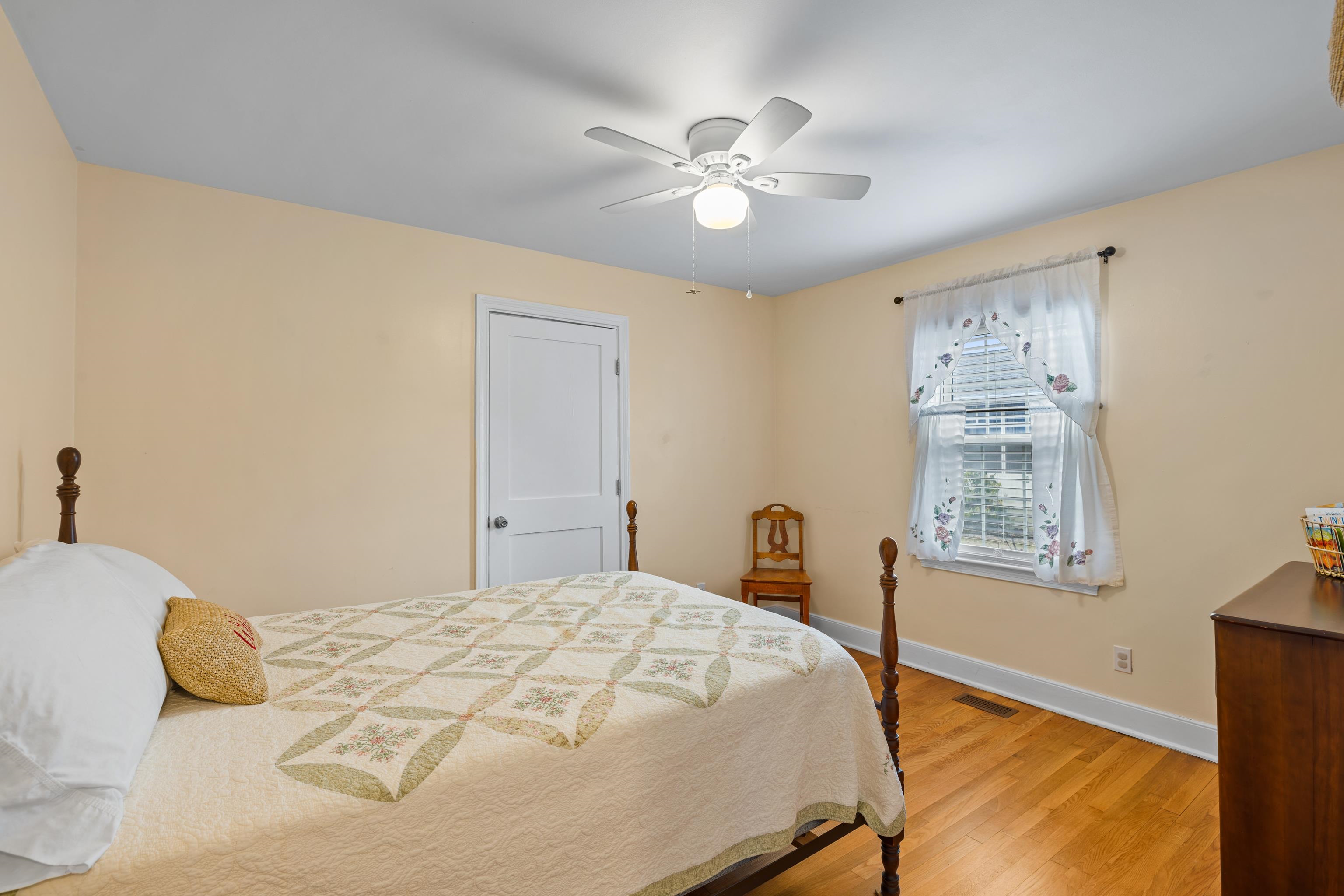 212 Alphin Avenue Waynesboro, VA 22980 - Photo 26 of 63 a bedroom with a large bed and a chandelier