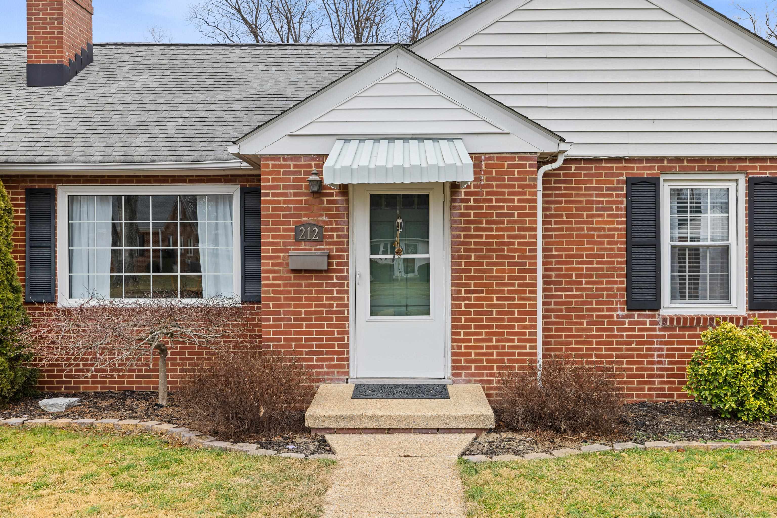 212 Alphin Avenue Waynesboro, VA 22980 - Photo 3 of 63 a front view of a house with a yard and garage