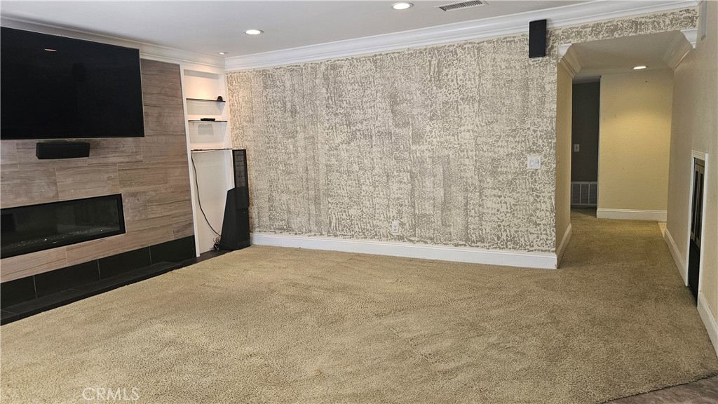 24722 Bracken Lane Stevenson Ranch, CA 91381 - Photo 14 of 36 a view of empty room with a fireplace and a flat screen tv