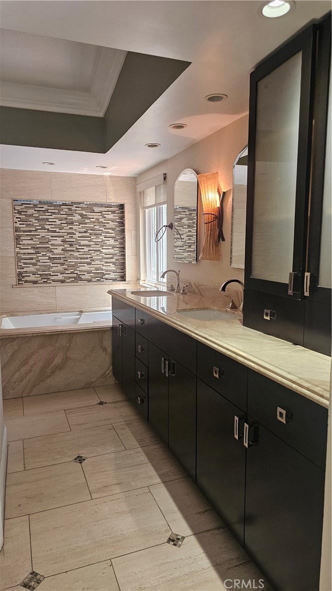 24722 Bracken Lane Stevenson Ranch, CA 91381 - Photo 17 of 36 a spacious bathroom with a double vanity sink a mirror and a bathtub