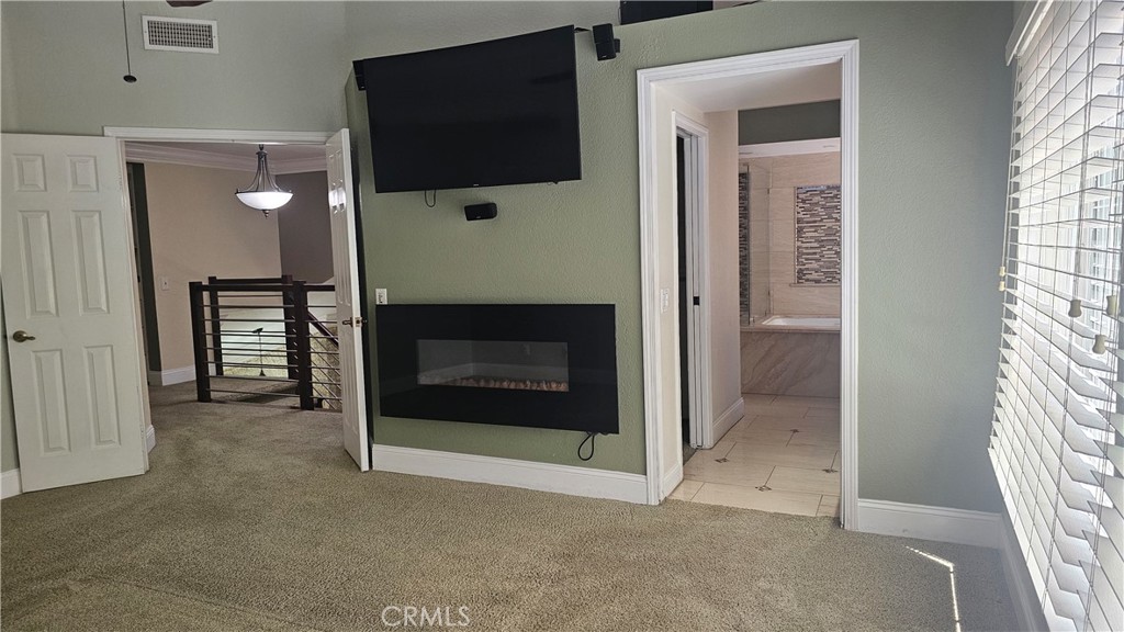 24722 Bracken Lane Stevenson Ranch, CA 91381 - Photo 18 of 36 a living room with a fireplace and a flat screen tv