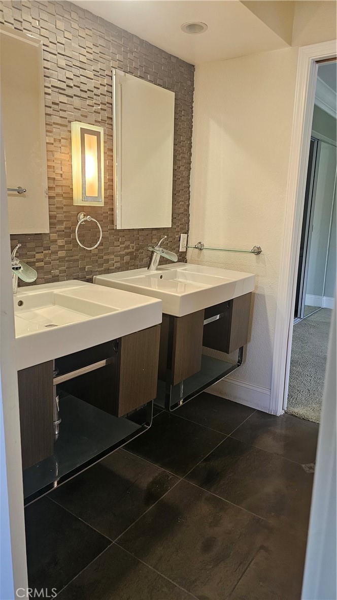 24722 Bracken Lane Stevenson Ranch, CA 91381 - Photo 19 of 36 a bathroom with a sink and a mirror