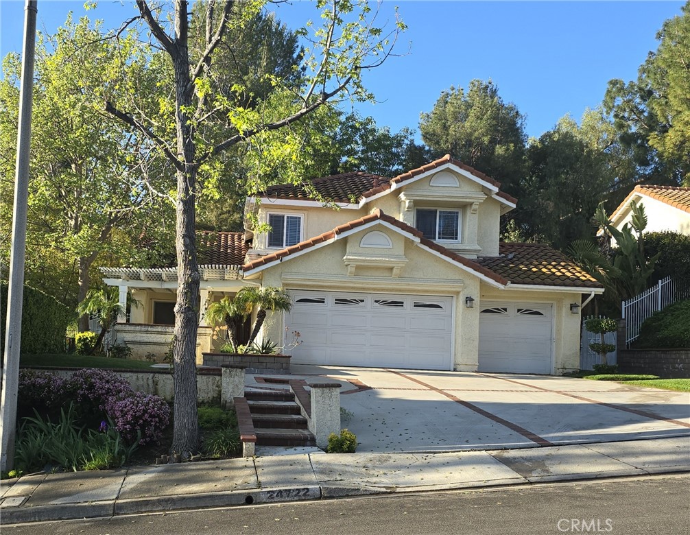 24722 Bracken Lane Stevenson Ranch, CA 91381 - Photo 2 of 36 a front view of a house with a garden
