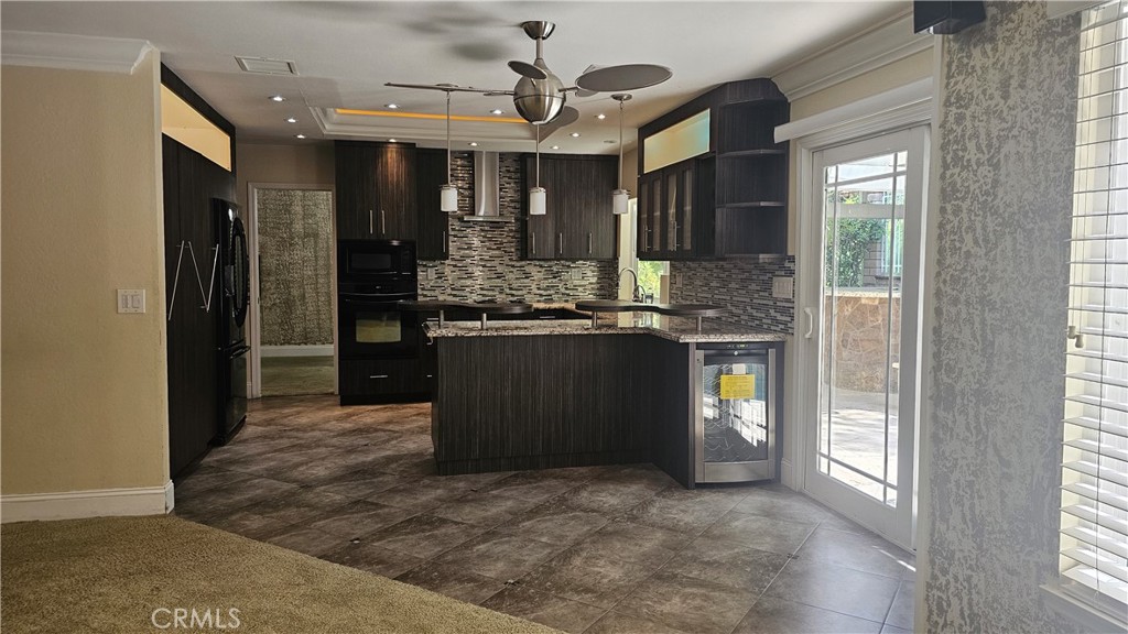 24722 Bracken Lane Stevenson Ranch, CA 91381 - Photo 29 of 36 a kitchen with stainless steel appliances granite countertop a refrigerator and a sink