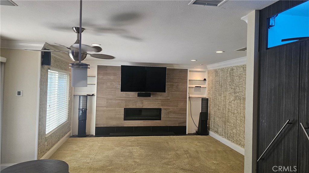 24722 Bracken Lane Stevenson Ranch, CA 91381 - Photo 30 of 36 a view of a livingroom with furniture flat screen tv and refrigerator
