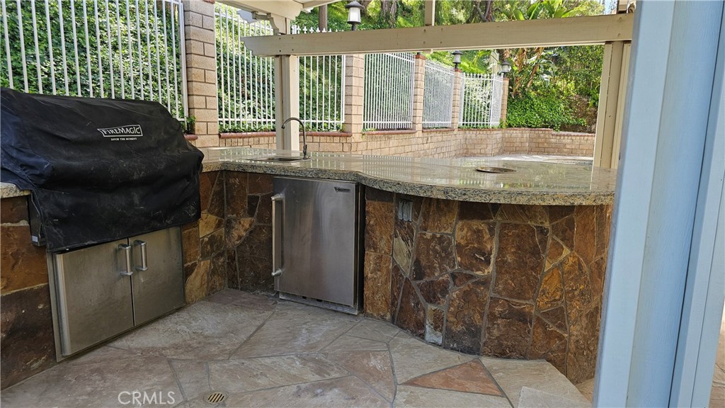 24722 Bracken Lane Stevenson Ranch, CA 91381 - Photo 33 of 36 a kitchen with a sink and large window