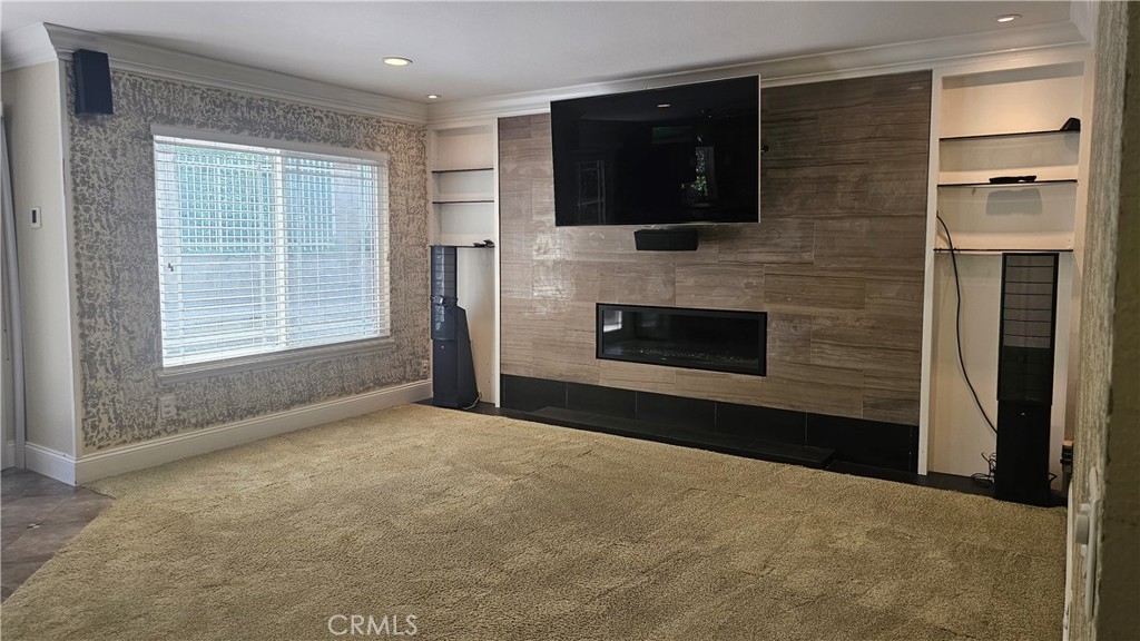 24722 Bracken Lane Stevenson Ranch, CA 91381 - Photo 4 of 36 a view of empty room with a fireplace and a flat screen tv