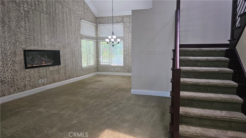 24722 Bracken Lane Stevenson Ranch, CA 91381 - Photo 5 of 36 a view of an empty room with stairs and a fireplace