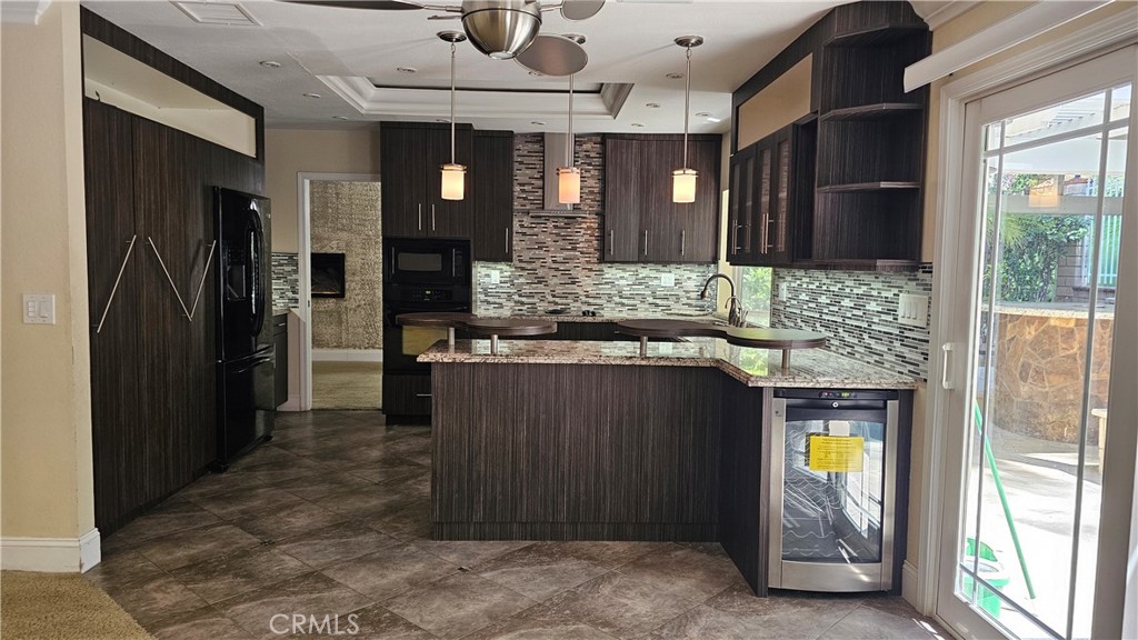 24722 Bracken Lane Stevenson Ranch, CA 91381 - Photo 7 of 36 a kitchen with stainless steel appliances granite countertop a refrigerator and a sink