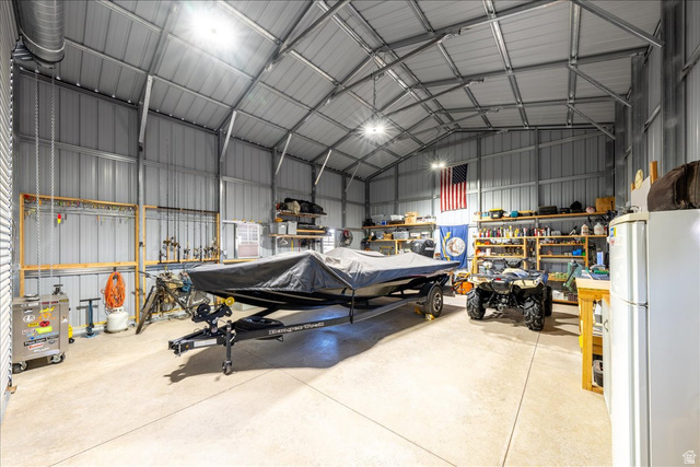 357 East Main Street Enterprise, UT 84725 - Photo 65 of 71 Garage with freestanding refrigerator, metal wall, and a workshop area