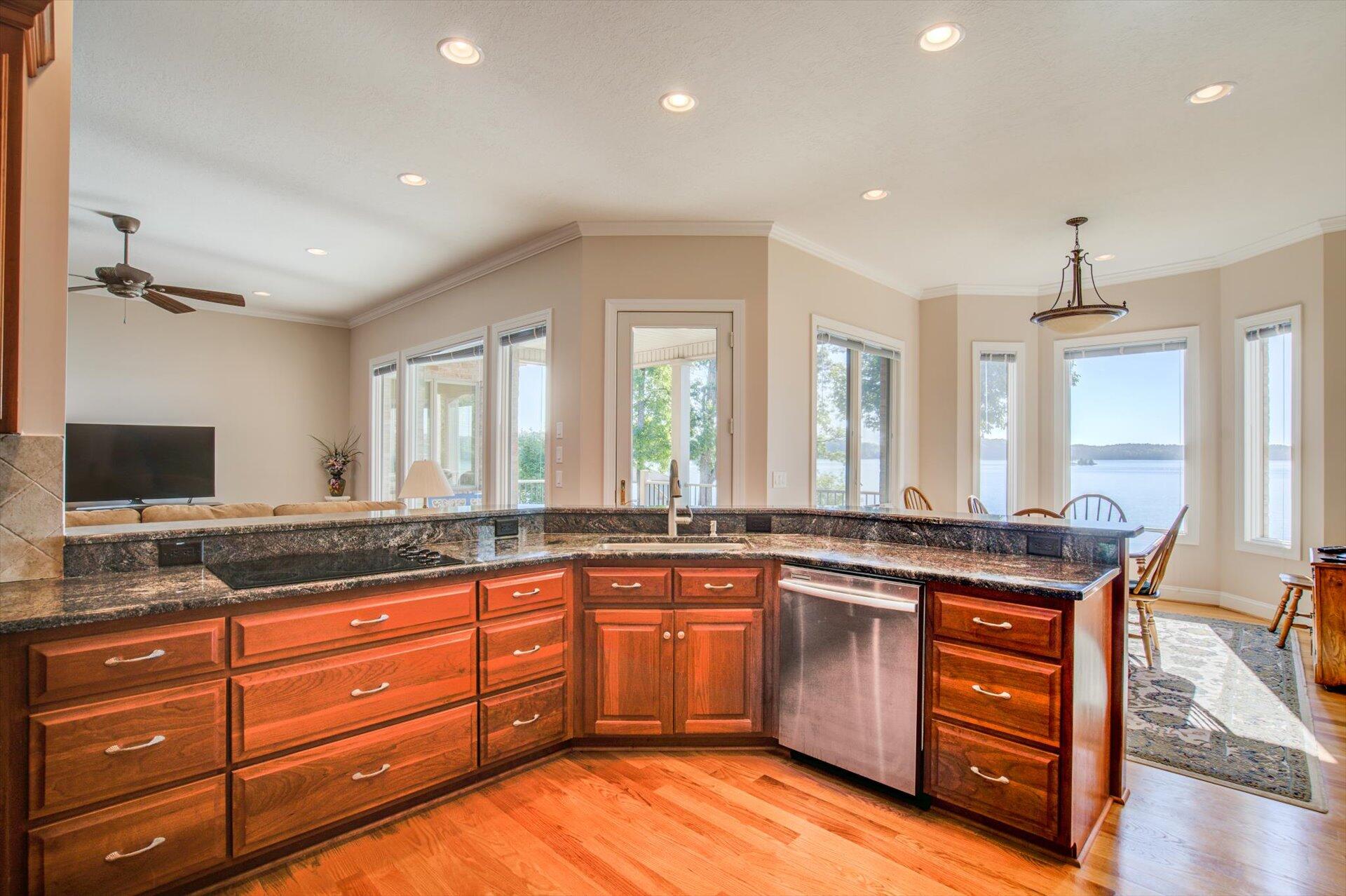 249 Pine Bay Drive Union Hall, VA 24176 - Photo 21 of 62 a kitchen with stainless steel appliances granite countertop wooden cabinets and a granite counter tops with a large window